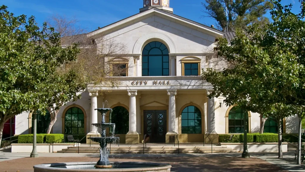 Fillmore City Hall, a cream building with a small dome and a fountain in front