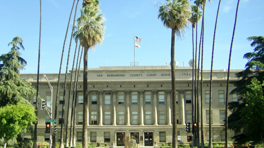 The historic San Bernardino County Courthouse, a columned 1926 building framed by tall palm trees in downtown San Bernardino
