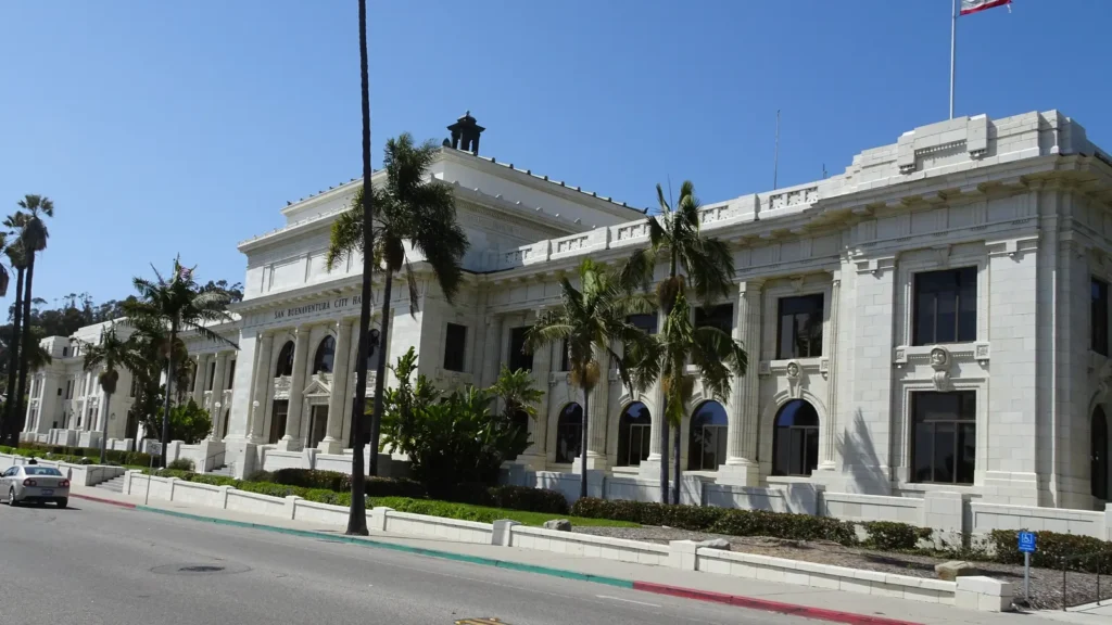 The historic Ventura County Courthouse, a white Beaux-Arts building with palm trees, now Ventura City Hall