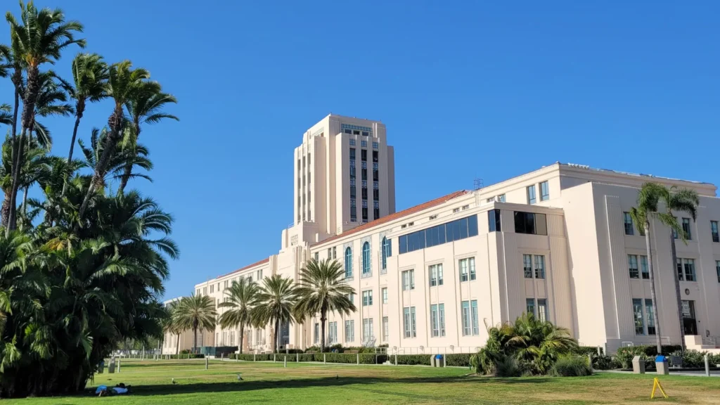 The San Diego County Administration Center, a cream-colored building with a central tower and palm trees, on the San Diego waterfront