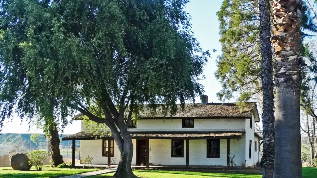 The historic Yucaipa Adobe under shade trees