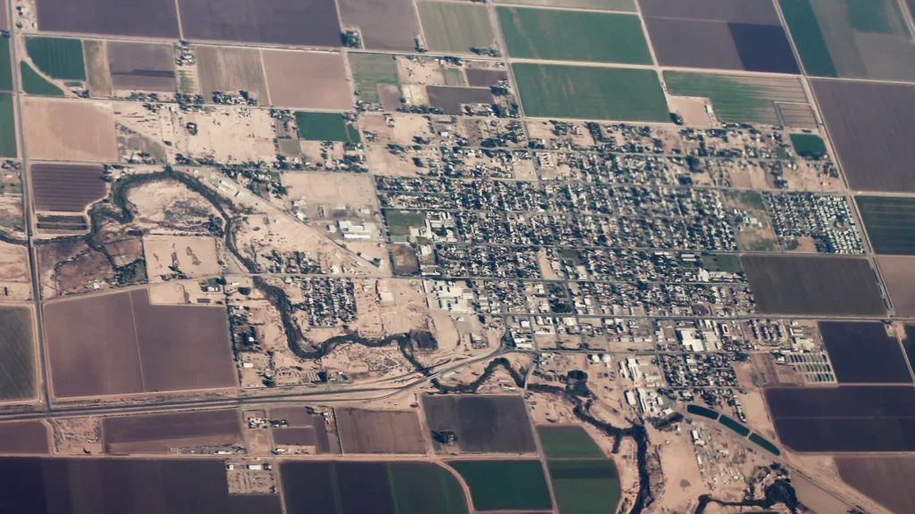 Aerial view of the small grid of Holtville surrounded by green and brown farm fields in the Imperial Valley