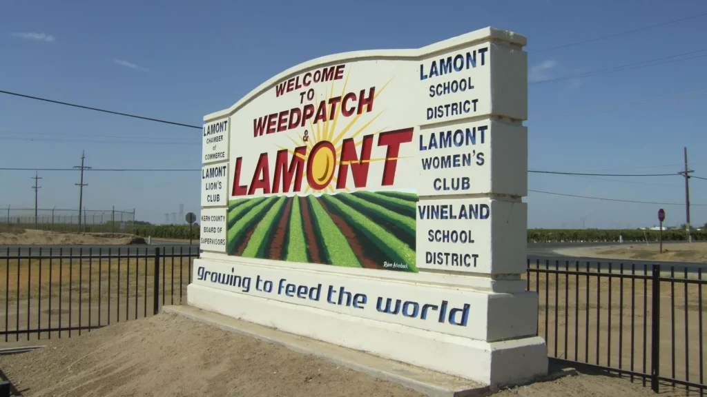 The Welcome to Weedpatch and Lamont sign, reading Growing to feed the world