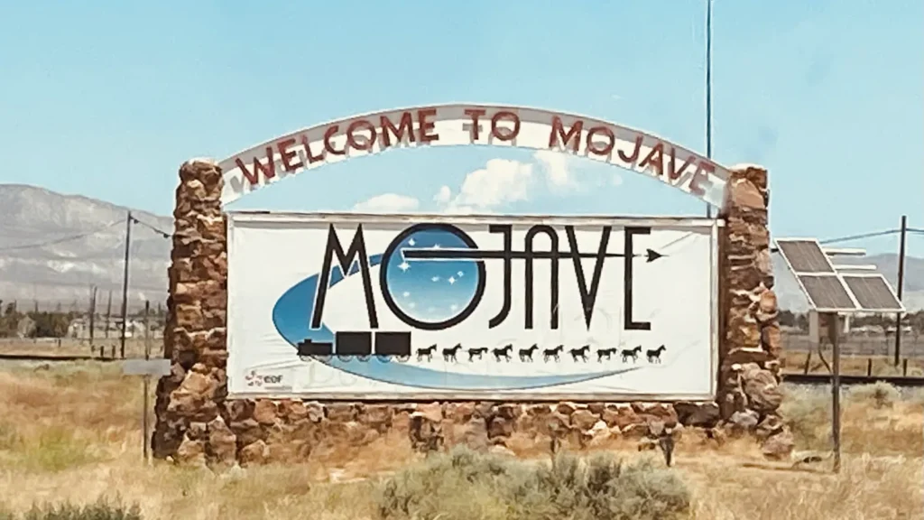 The stone Welcome to Mojave sign in the desert